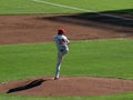 Pitcher lifts leg high as he sets to throw pitch
