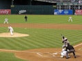 Pitcher throws pitch to batter with ball in air