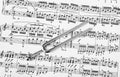 Pitchfork on sheet music - art background Royalty Free Stock Photo