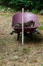 A pitchfork and a wheelbarrow with compost in it