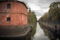 Piterburg`s ancient building surrounded with a ditch with water Royalty Free Stock Photo