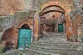 Pitigliano, Tuscany, Italy: old stairway, cellar doors and medieval city door 