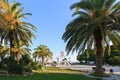 PITSUNDA, ABKHAZIA, SEPTEMBER 19, 2017: Green beautiful palm trees and sculptural composition `The Sea` in the center of Pitsunda