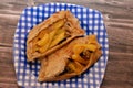 A pitta flatbread filled with mixture of potatoes fried fingers, mashed fava beans, fried aubergine, Egyptian falafel green burger