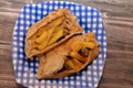 A pitta flatbread filled with mixture of potatoes fried fingers, mashed fava beans, fried aubergine, Egyptian falafel green burger