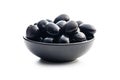 Pitted black olives in bowl isolated on white background Royalty Free Stock Photo