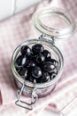 Pitted black olives in jar Royalty Free Stock Photo