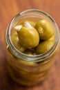 Pitted green olives stuffed with almonds in jar Royalty Free Stock Photo