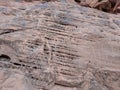 Pitted sandstone with ancient petroglyphs on mountain in Valley of Fire Nevada Royalty Free Stock Photo