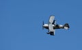 Pitts Model 12  stunt byplane  with smoke trail and blue sky. Royalty Free Stock Photo