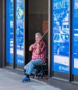 Pittsburgh, Pennsylvania, USA April 27, 2023 A man playing violin in a storefront entranceway on Forbes Avenue