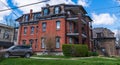 Pittsburgh, Pennsylvania, USA April 13, 2024 An old three-story brick apartment building on Braddock Avenue