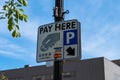 Pittsburgh, Pennsylvania, USA April 27, 2023 A pay here sign for parking on Forbes Avenue in the Squirrel Hill Royalty Free Stock Photo