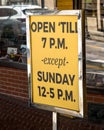 Pittsburgh, Pennsylvania, USA April 27, 2023 A sign showing store hours on Forbes Avenue