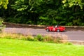 A red convertible sports car in the race