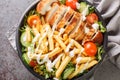 Pittsburgh steak salad consists of a bed of lettuce that`s topped with tomatoes, cucumbers, a piece of grilled chicken, and crisp
