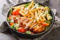 Pittsburgh steak salad consists of a bed of lettuce that`s topped with tomatoes, cucumbers, a piece of grilled chicken, and crisp