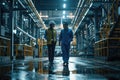 Pixel Perfect Image of Two Engineers Wearing Helmets Walking in Factory Setting Royalty Free Stock Photo