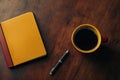 Pixel Perfect Picture of High Angle View of Coffee by Book and Pen on Table Royalty Free Stock Photo