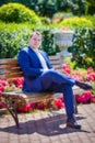 Pixelized portrait of a man in blue costume sitting on bench