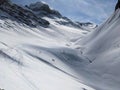 Piz Ducan above Sertig. Fantastic mountain landscape in deep winter. Skimo in Switzerland. Big mountains and valley Royalty Free Stock Photo