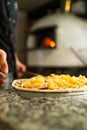 Pizaiolo Praparing Pizza for Baking in Wood Fired Oven Royalty Free Stock Photo