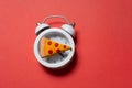 Alarm clock with a piece of pizza.  Pizza time. Snack time Royalty Free Stock Photo