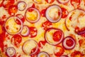 Pizza background. Close-up of melted cheese red onion and tomato