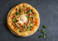 Pizza with bacon, egg and green peas. Breakfast pizza on a gray background, top view.