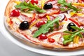 Pizza with bacon, olives and red pepper on a white plate Royalty Free Stock Photo