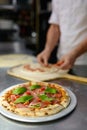 Pizza baking process closeup on freshly cooked Italian pastry