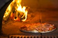 Pizza baking in traditional stone oven Royalty Free Stock Photo