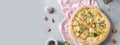 Pizza banner. Delicious pizza with pear, mozzarella, blue cheese, walnuts and microgreen on gray table. Top view, copy space.