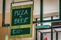 Pizza and beer for ten dollars sign