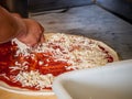 Pizza being assembled Royalty Free Stock Photo