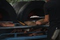Pizza being cooked in woodfired pizza oven at outdoor party with generic unbranded pizza boxes