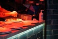 Pizza being prepared under heatlamp