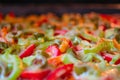 Pizza with bell pepper, meat, vegetables, melted cheese, tomato and green olives. Selective focus, close-up. Royalty Free Stock Photo