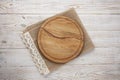 Pizza board, canvas napkin with lace on wooden table. Top view mock up