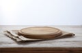 Pizza board, canvas napkin with lace on wooden table. Top view mock up