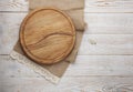 Pizza board, canvas napkin with lace on wooden table. Top view mock up