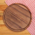 Pizza board with napkin on wooden table. Top view mockup