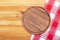 Pizza board with napkin on wooden table. Top view mockup