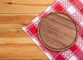 Pizza board with napkin on wooden table. Top view mockup