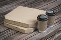 Pizza boxes and coffee plastic cups on vintage wooden planks. Fast food take away mock up