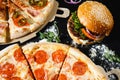 Pizza and burger on a black background. Top view Royalty Free Stock Photo