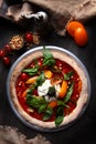 Pizza with burrata cheese and pine nuts. Italian pizza. Metal plate for serving. Green basil leaves. Vertical photo. View from Royalty Free Stock Photo