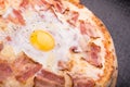 Pizza carbonara with bacon and raw hicken egg Royalty Free Stock Photo