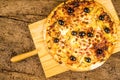 Pizza carbonara on kitchen table Royalty Free Stock Photo