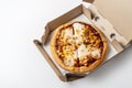 Pizza in a cardboard box on a white background. View from above. Pizza delivery. Copy space for text Royalty Free Stock Photo